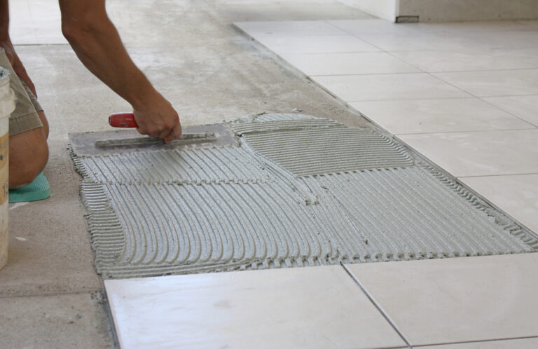 male tiler tiling the floor