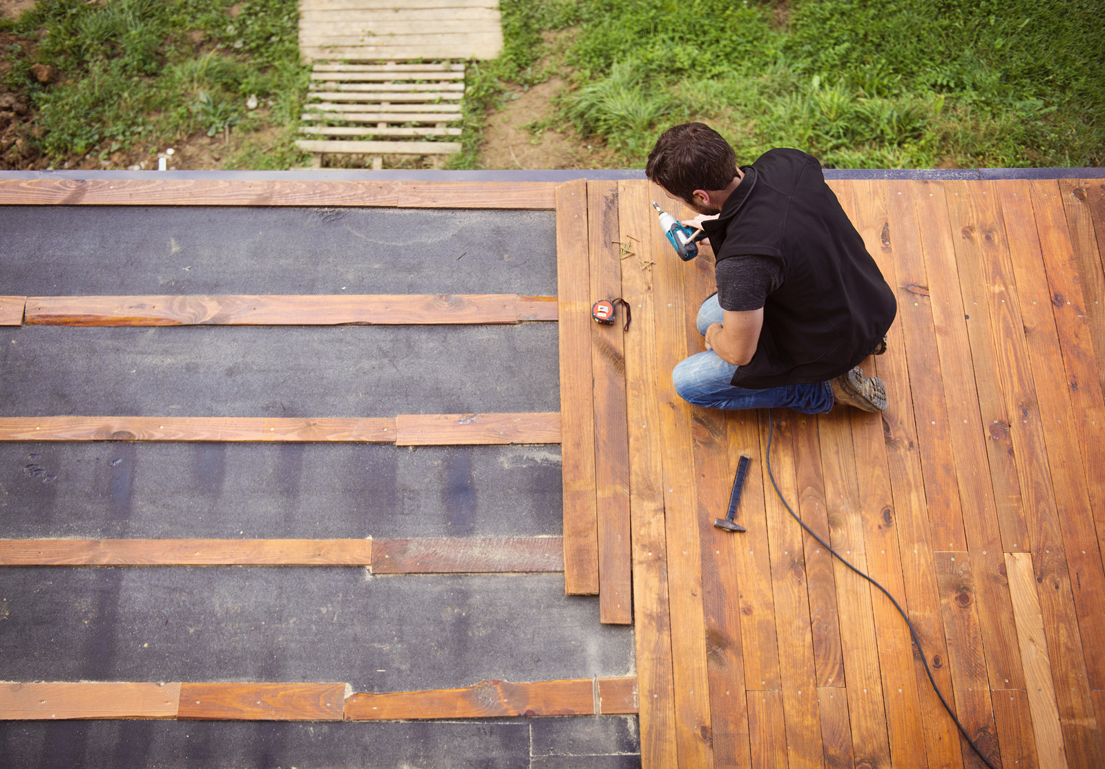 Handyman installing wooden flooring