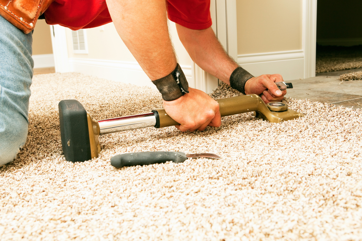 Installer Using Knee Kicker to Stretch Threshold Carpet